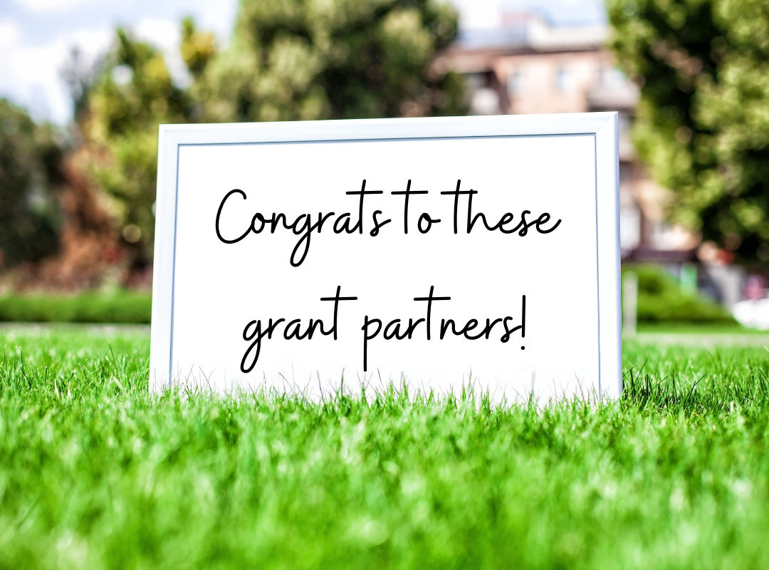 card in grass that says congrats to these grant partners