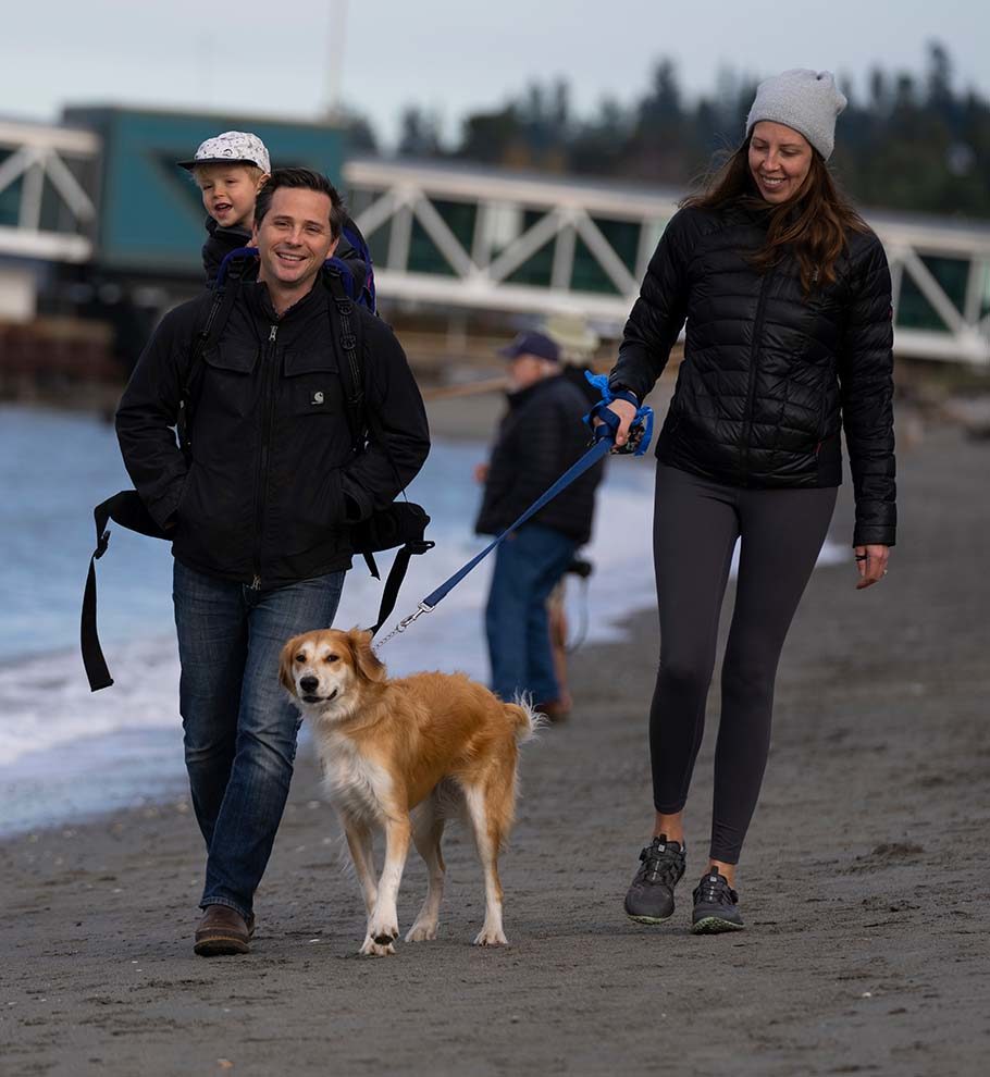 Mother, father and child walking dog at Edmonds waterfront