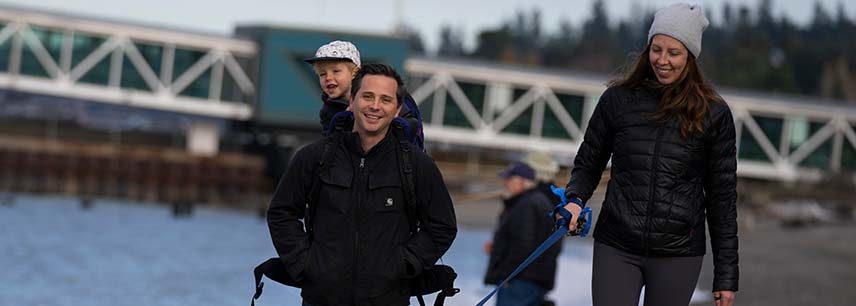 Mother, father and child walking dog at Edmonds waterfront
